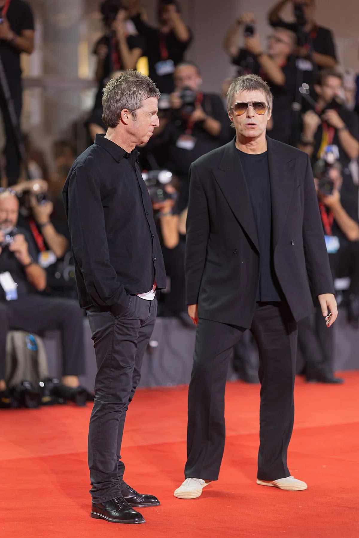 Noel and Liam Gallagher pose on the red carpet at the Venice Film Festival.