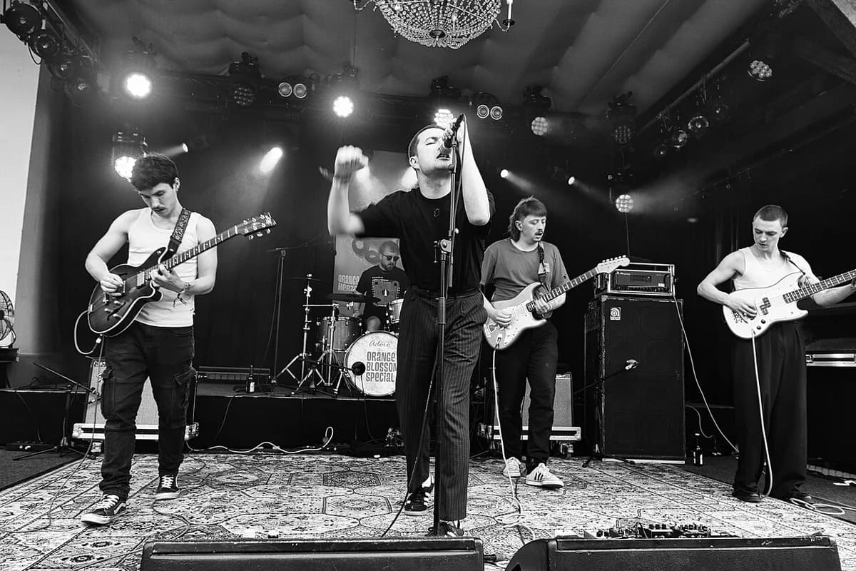 Black-and-white photo of Gurriers performing live on stage at a festival.