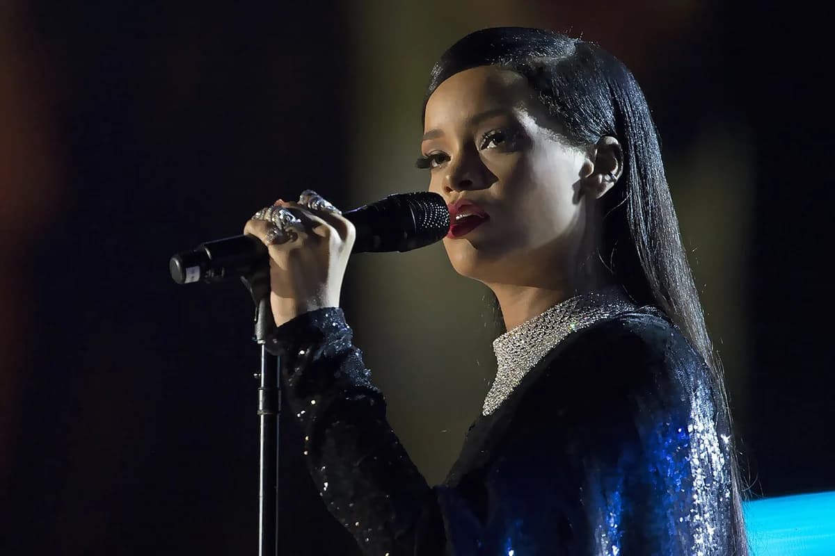 Rihanna singing on stage into a microphone.