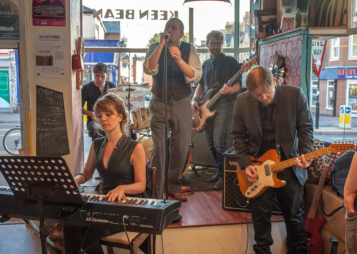A band performing live inside a small shop venue.