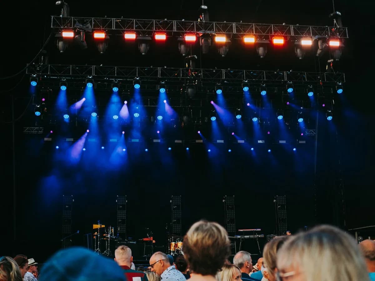 Empty stage with blue and red lights and blurred audience