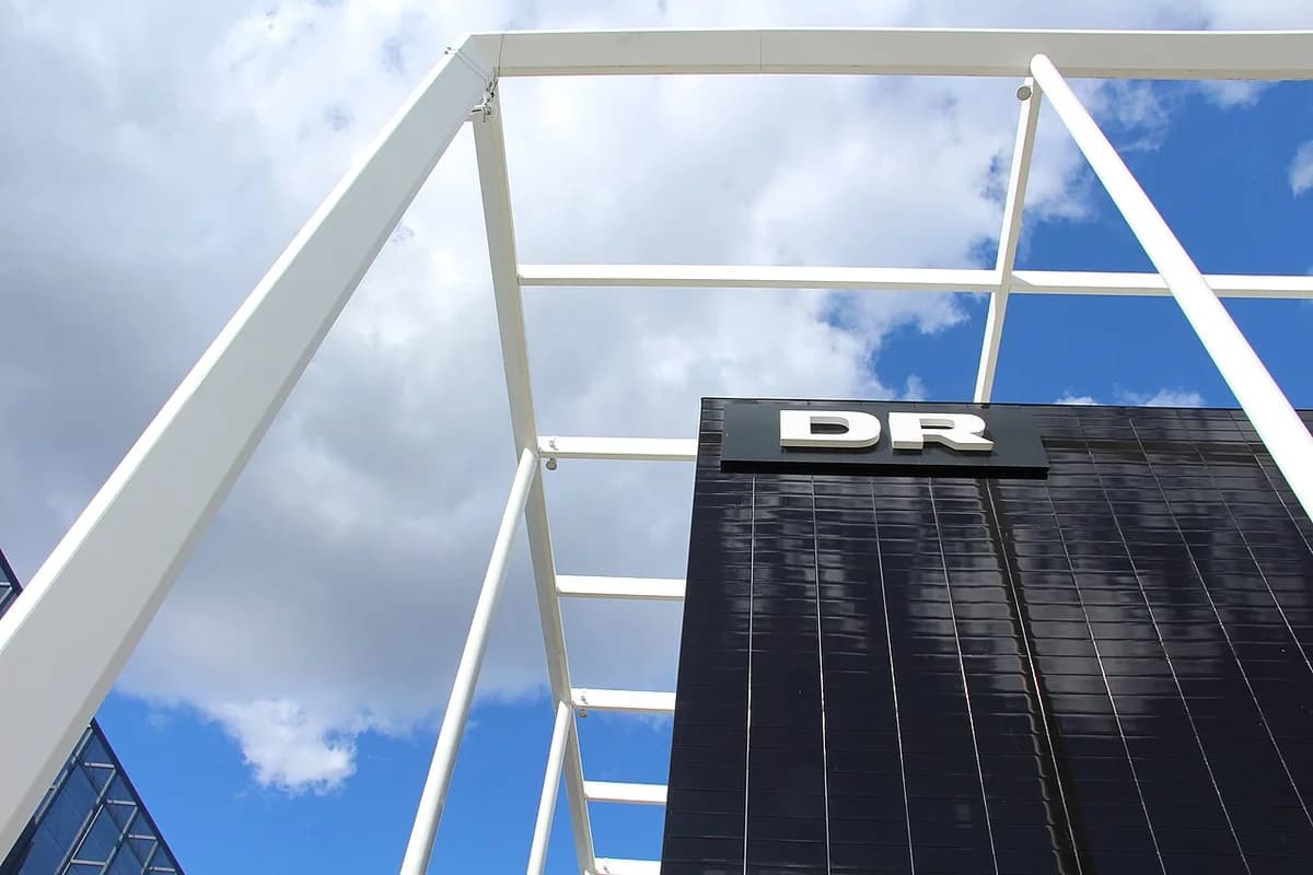 DR building facade with logo and white frame against sky