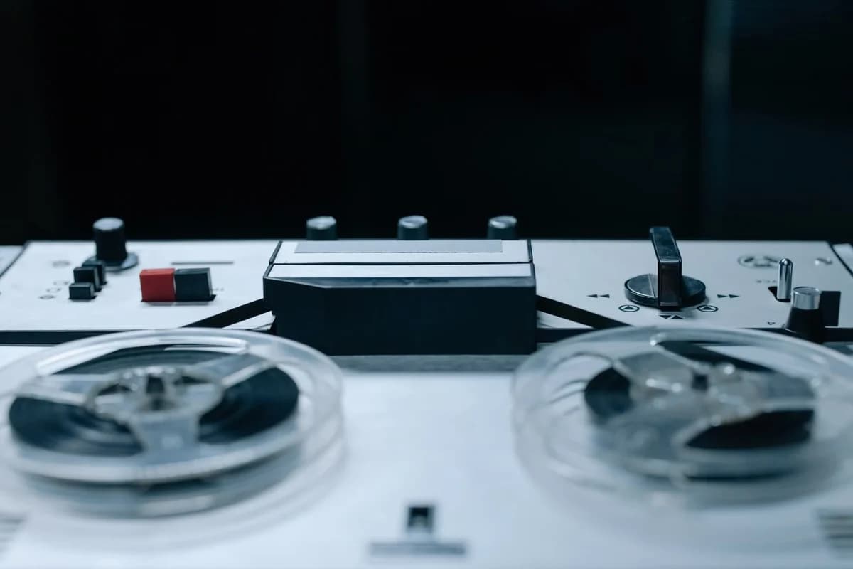 close-up of reel-to-reel tape recorder with control buttons and tape reels