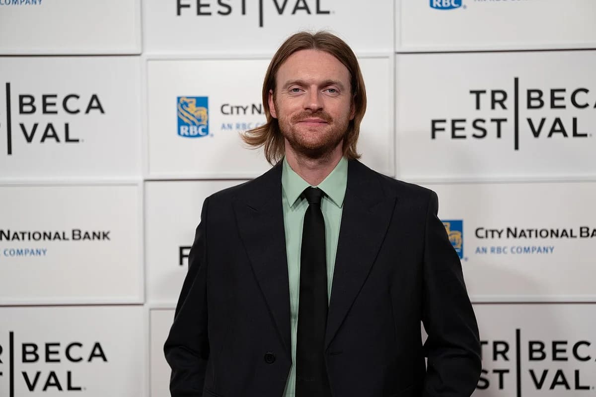 Finneas at Tribeca Festival 2026 in front of branded backdrop