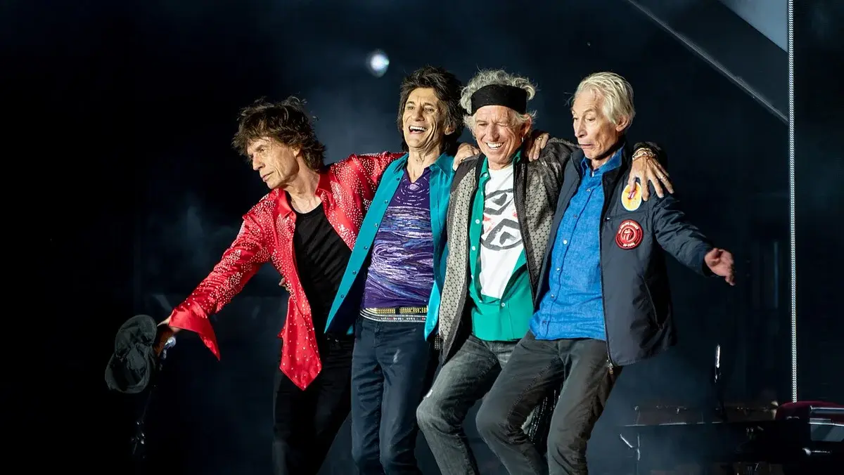 The Rolling Stones bow on stage after a concert.