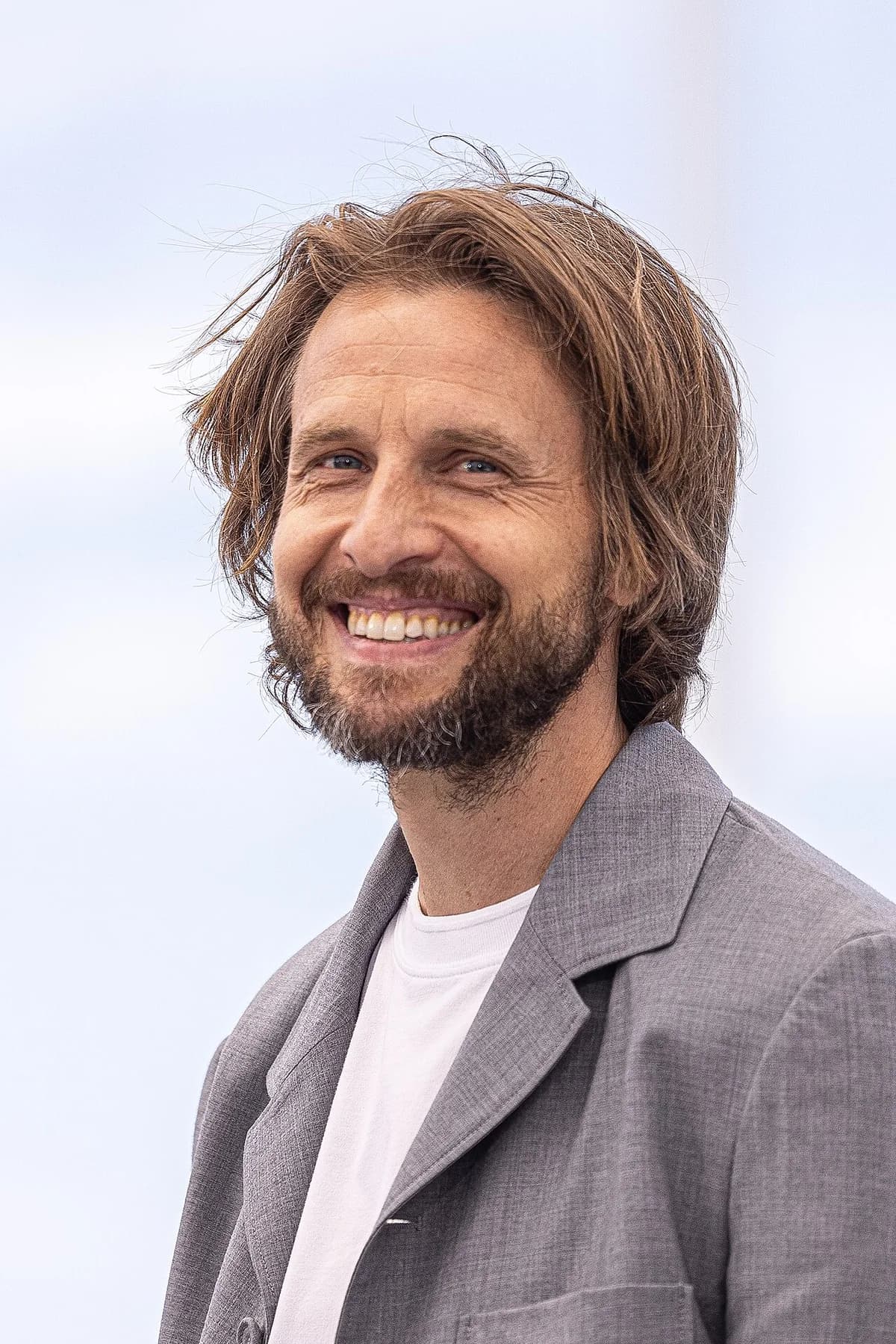 Portrait of Anders Danielsen Lie smiling at Cannes Film Festival 2025.