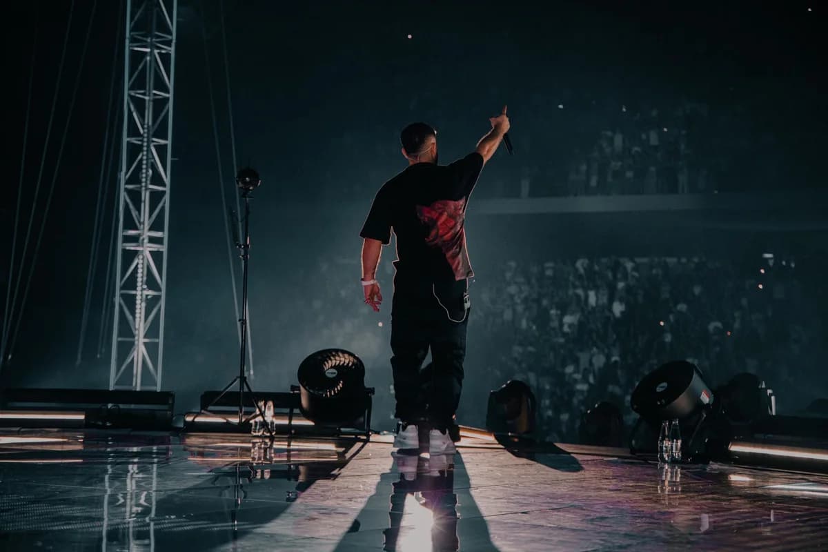 Rapper performing on stage in front of a crowd