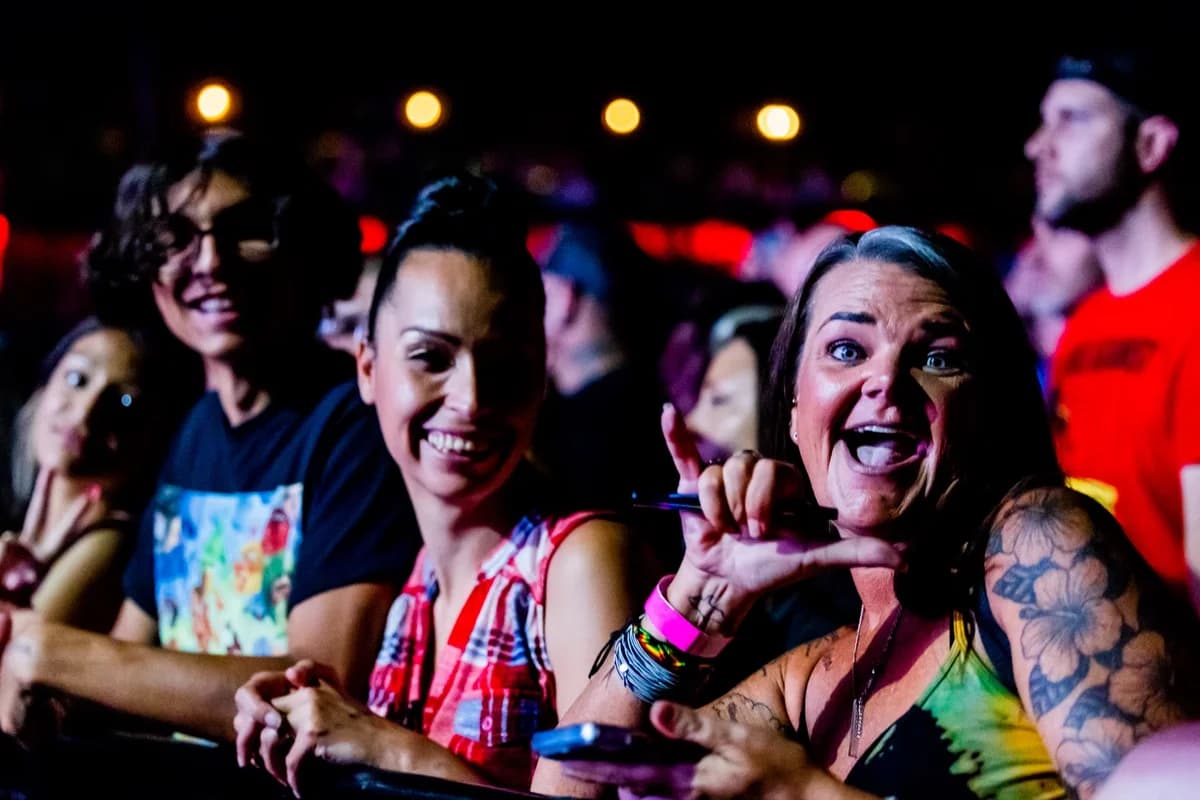 Excited audience members at a lively concert