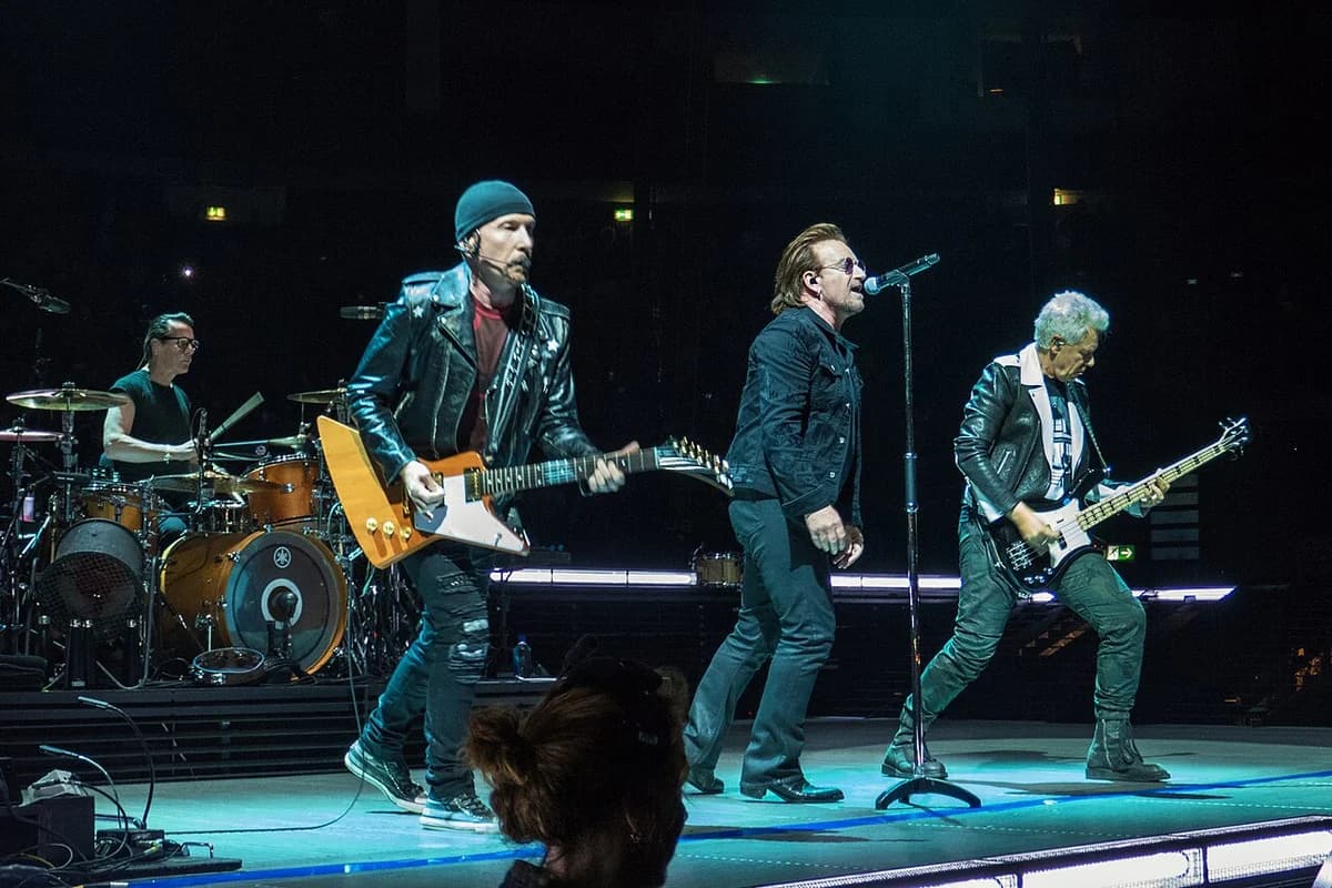 U2 performing live on stage in Berlin.