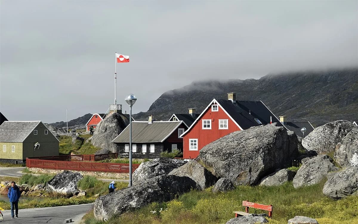 Colorful houses and large rocks near the Nanortalik Museum in Greenland.
