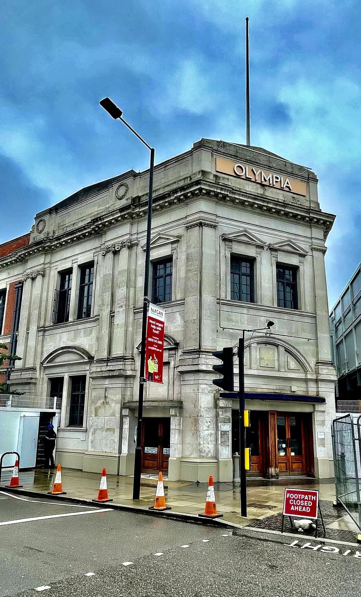 Facade of Olympia London on a city street.