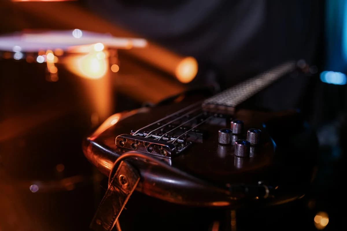 Close-up of an electric guitar under warm stage lights.