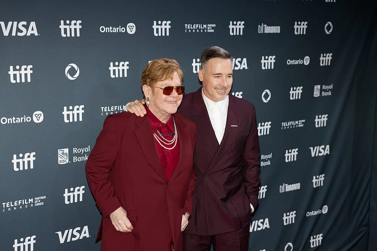 Elton John and David Furnish posing at TIFF 2024